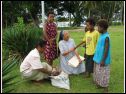 Children bring coconut to Sr. Mary Jeannette.JPG